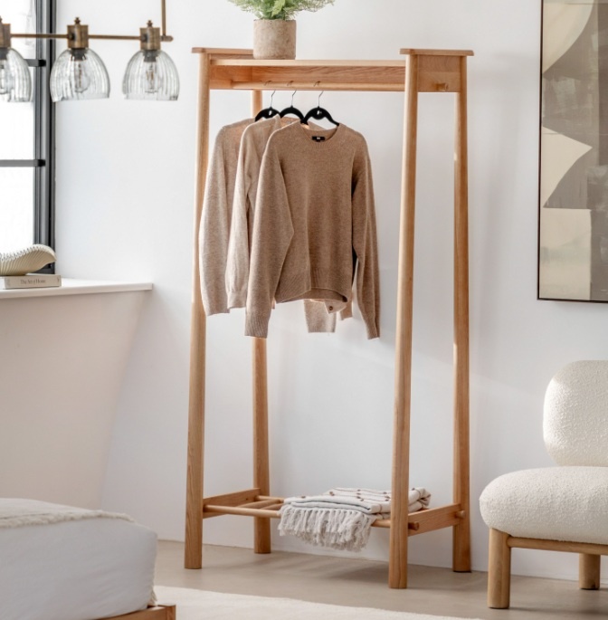 Gallery Direct Wycombe Open Wardrobe in a modern styled room, with jumpers hanging off the hanging rail