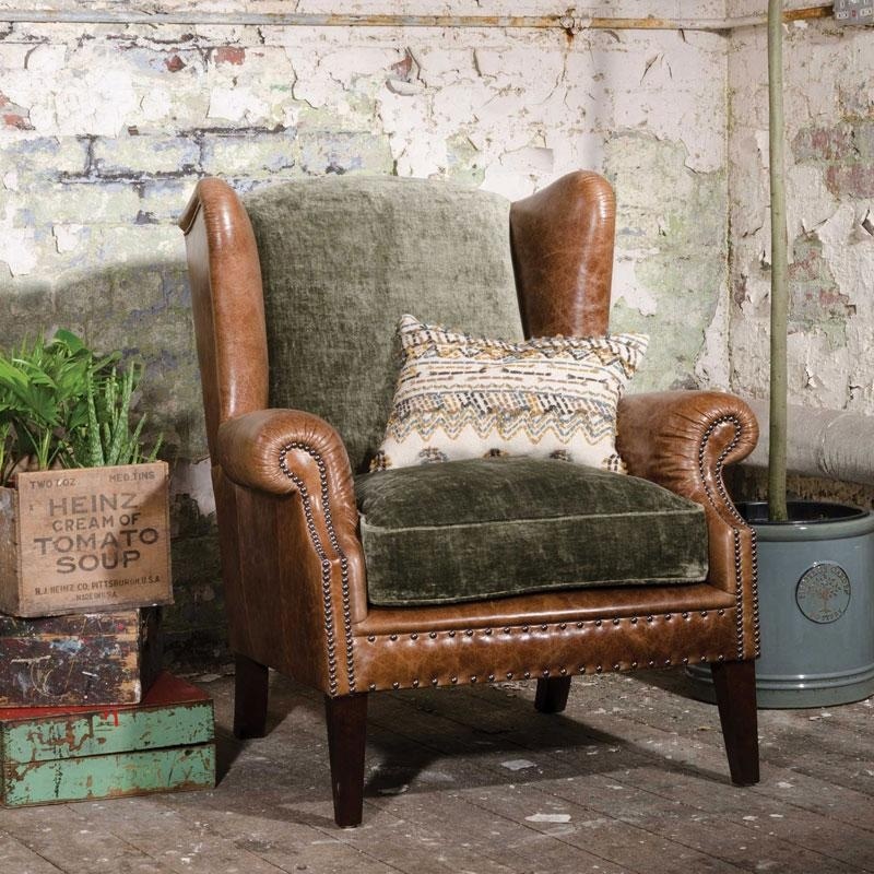 Tetrad Constable Wing Chair in a traditional looking room with stone walls and a wooden floor