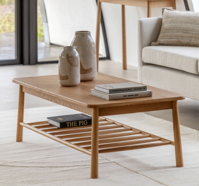 Gallery Direct Wycombe Rectangle Coffee Table with natural oak finish and spindle shelf styled in a bright Nordic living room