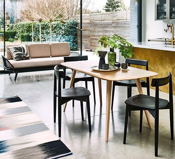 Ercol 1990 Lara Chair around a dining table in a bright and airy room