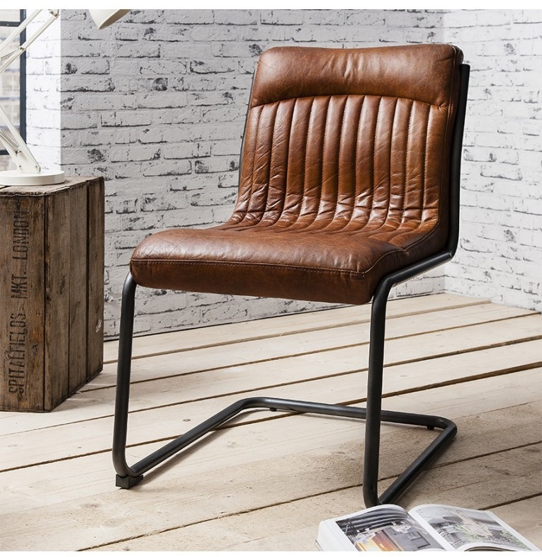 Vintage Brown Leather Capri Chair by Gallery Direct styled in a modern industrial loft with exposed brick and natural wood fl
