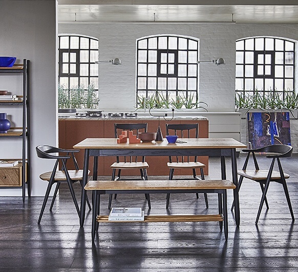 Modern industrial dining room featuring the Ercol Monza bench, medium extending table and Como chairs - Brentham Furniture