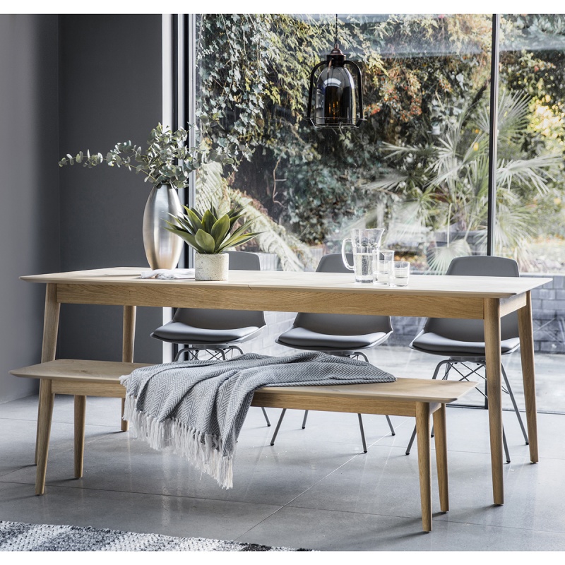 Gallery Milano Extending Dining Table in European oak with chevron inlay, styled with bench in bright modern dining space