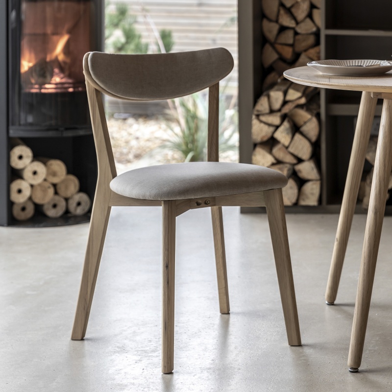 Gallery Hatfield Dining Chair Natural styled beside a dining table, featuring a rubberwood frame and neutral upholstered seat