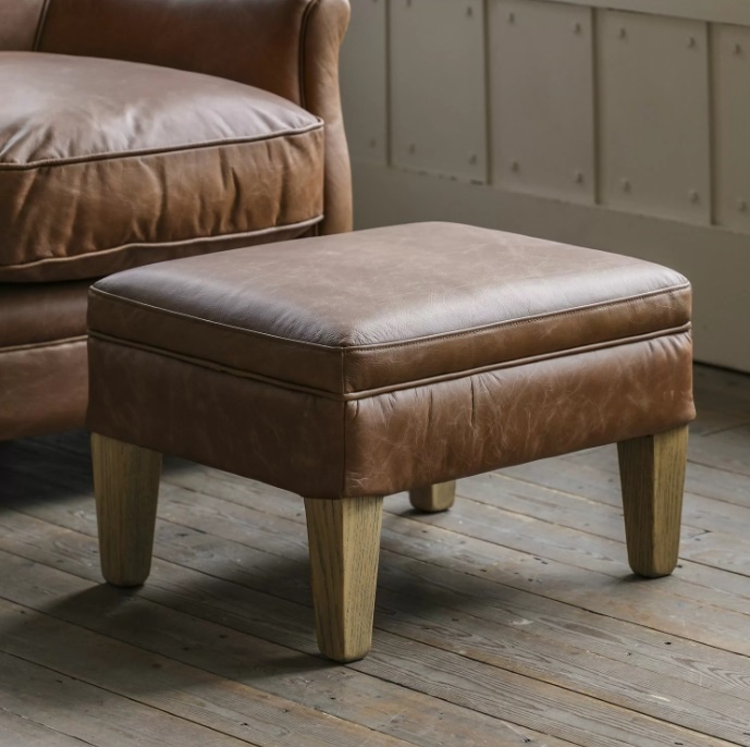 Gallery Direct Mr. Paddington Stool Vintage Brown Leather on a vintage wooden floor