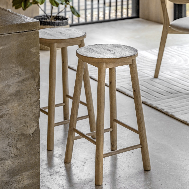 A pair of Gallery Hatfield Stool Natural against a modern breakfast bar