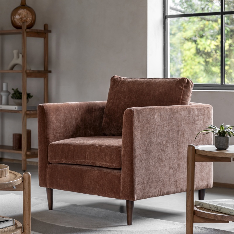 Gallery Direct Gateford Armchair Rust in soft fabric, styled in modern living space with wooden furniture and natural light
