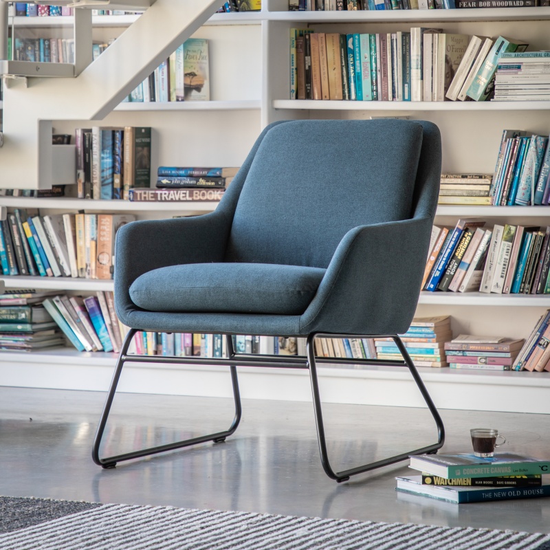 Gallery Direct Funton Chair Midnight Blue in front of a book case in a home office
