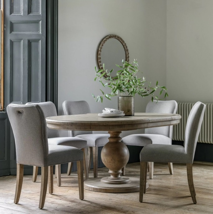 Gallery Direct Vancouver Round to Oval Extending Dining Table Set styled with matching fully upholstered Vancouver Dining Cha