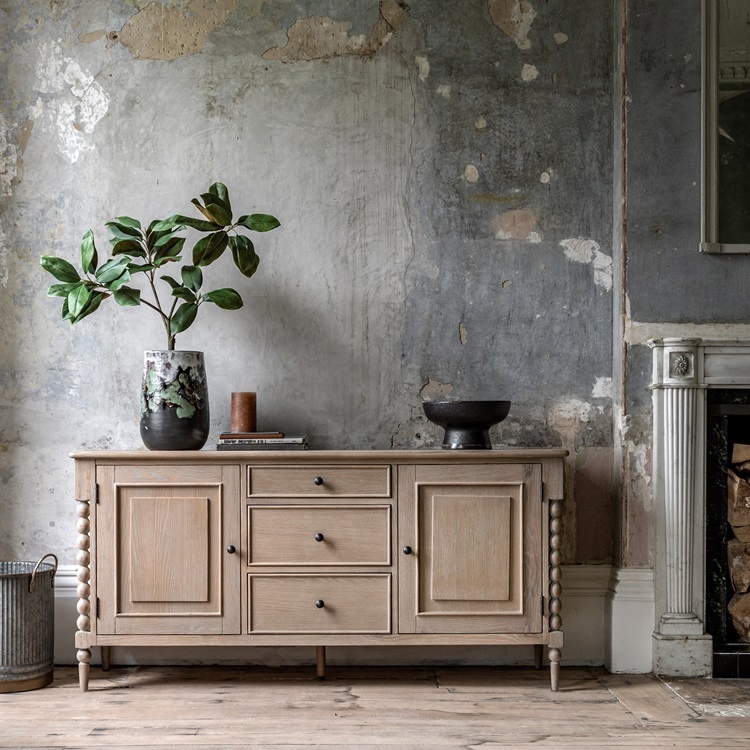 Lifestyle shot of the Gallery Direct Artisan 2 door 3 drawer sideboard in a bright living room.