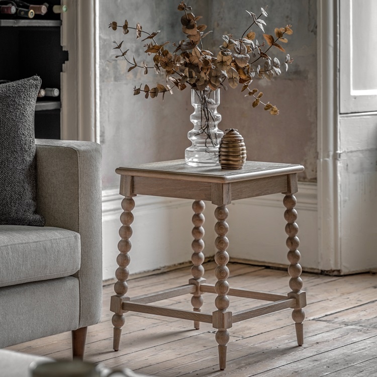 Gallery Artisan Side Table styled in a living room, showcasing handcrafted bobbin detailing and timeless oak design