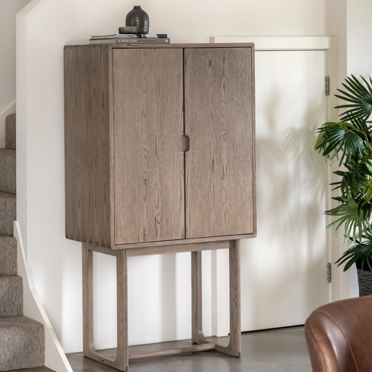 Gallery Direct Craft Cocktail Cabinet Smoked styled in a modern interior highlighting rich smoked oak grain and sleek design