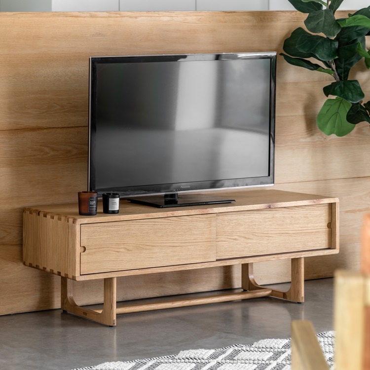 Gallery Direct Craft Media Unit Natural styled beneath a TV highlighting natural oak grain and modern living room design