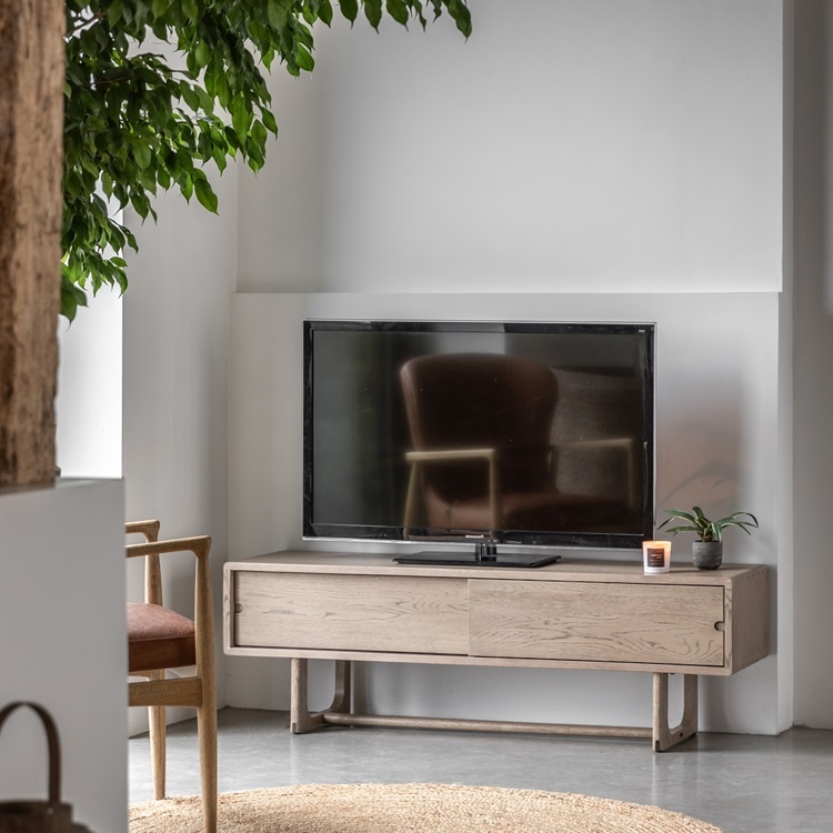 Gallery Direct Craft Media Unit Smoked styled beneath a TV highlighting smoked oak grain and modern living room design