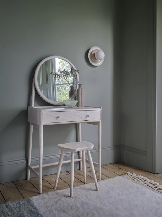 Ercol 7425 Saddle Stool paired with a dressing table and vanity mirror in a home