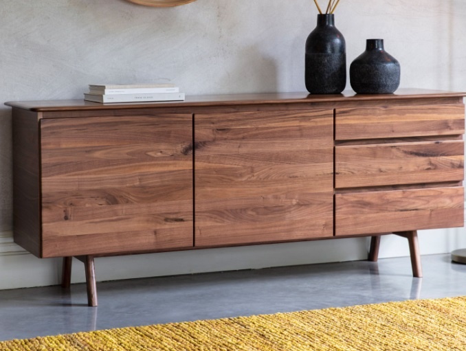 Stylish living room setting featuring Gallery Direct Madrid 2 Door 3 Drawer Sideboard Walnut in warm wood tone