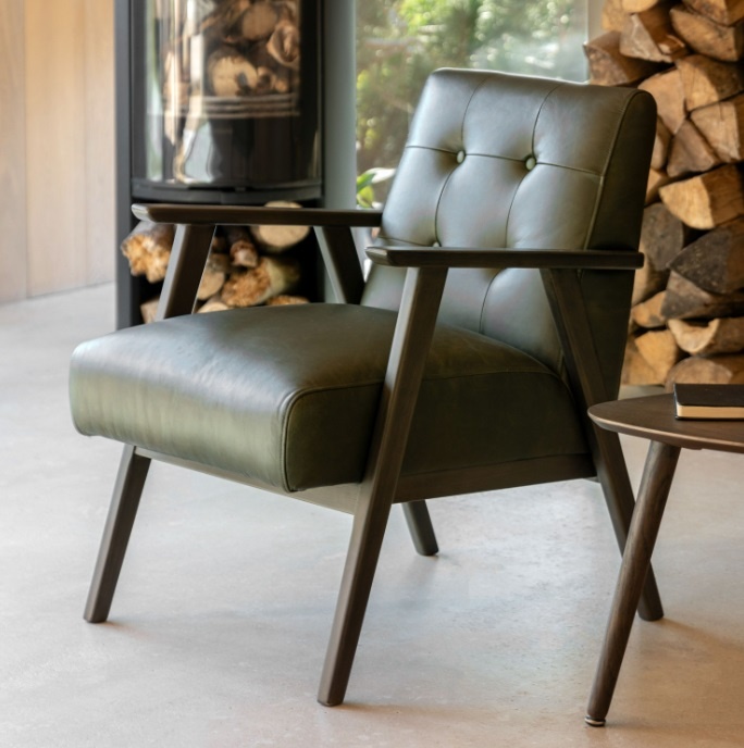Gallery Blackhall Armchair Heritage Green Leather with button-tufted back and dark wood frame in cosy interior