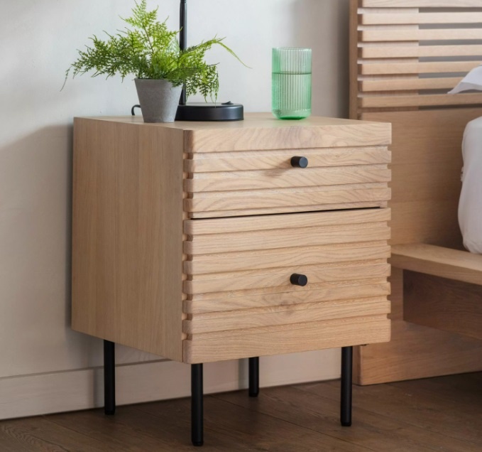 Styled bedroom setting featuring the Gallery Direct Okayama 2 Drawer Bedside with curved edges and black handles