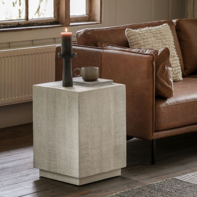 Gallery Iowa Side Table Whitewash beside a sofa on a wooden floor