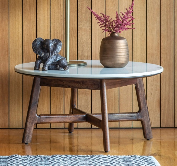 Gallery Barcelona Round Coffee Table against a wood panelled wall