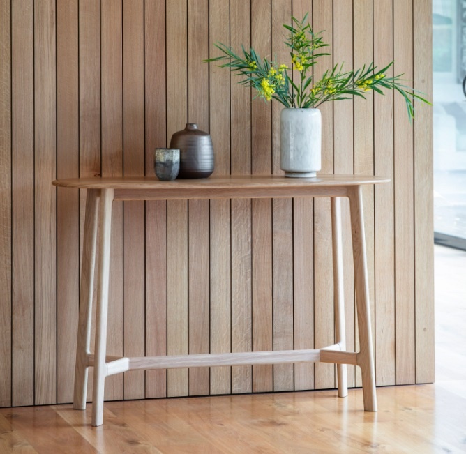 Gallery Direct Madrid Console Table Oak against a wood panelled wall in a modern home