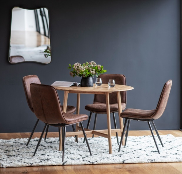 Gallery Direct Madrid Round Dining Table Oak paired with matching chairs in a contemporary dining setting
