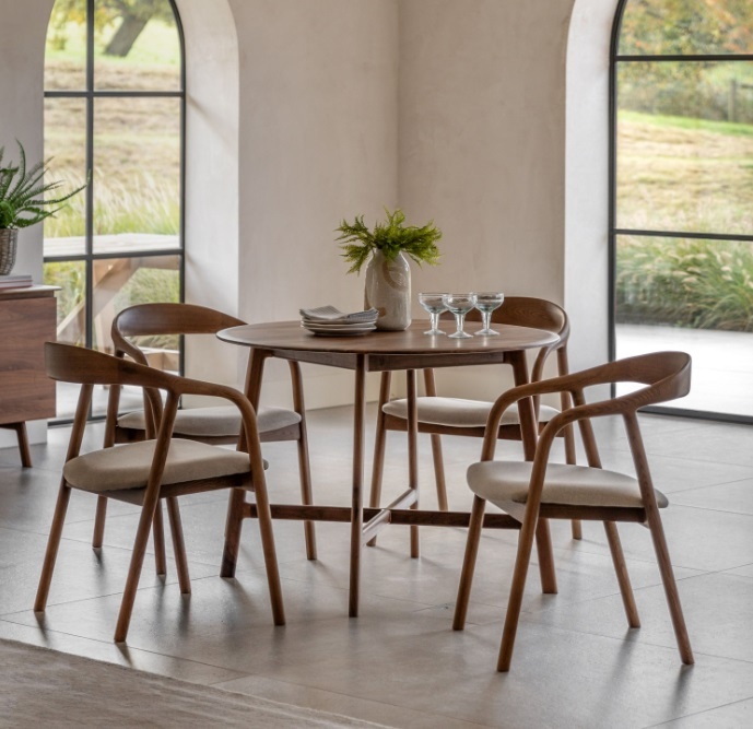 Gallery Direct Madrid Round Dining Table Walnut with matching chairs in a modern dining setting