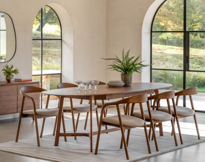 Gallery Direct Madrid Extending Dining Table Walnut styled in a bright dining space with solid walnut finish & modern chairs