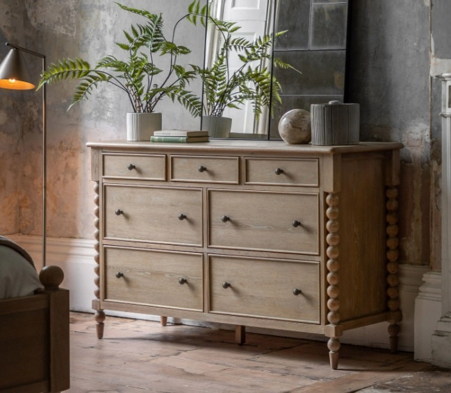 Lifestyle shot of the Gallery Direct Artisan 7 drawer chest in a bright, modern room.