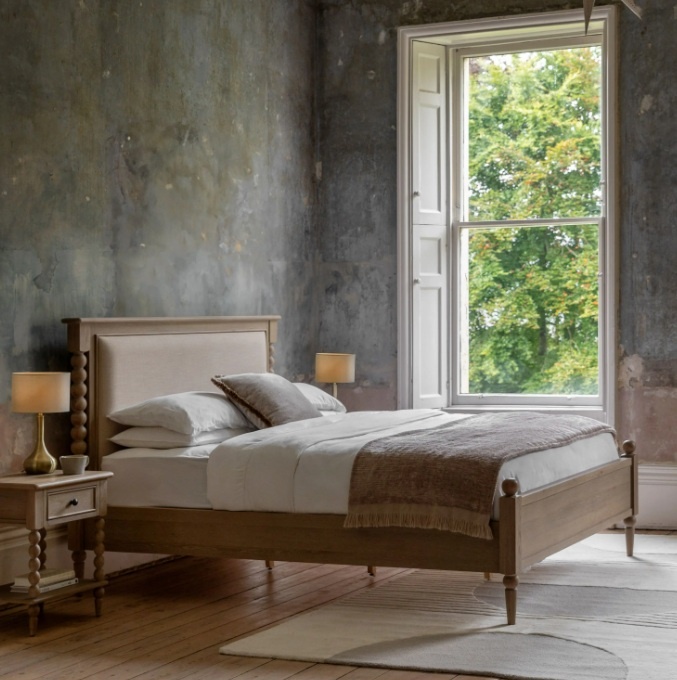 Lifestyle shot of a Gallery Direct Artisan super king oak bed in a bright, modern bedroom.