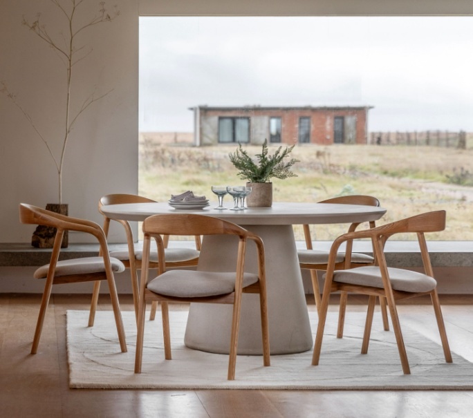 Gallery Pedra Round Dining Table Linen in a contemporary dining space