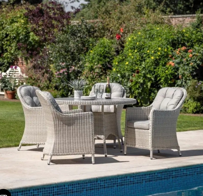 Gallery Direct Holton 4 Seater Round Dining Set next to swiiming pool on stone patio