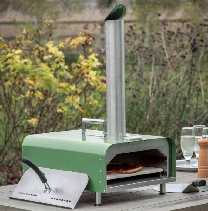 Outdoor setup featuring the Gallery Sassari Pellet Pizza Oven Black Green with stainless steel body and pellet-fed system
