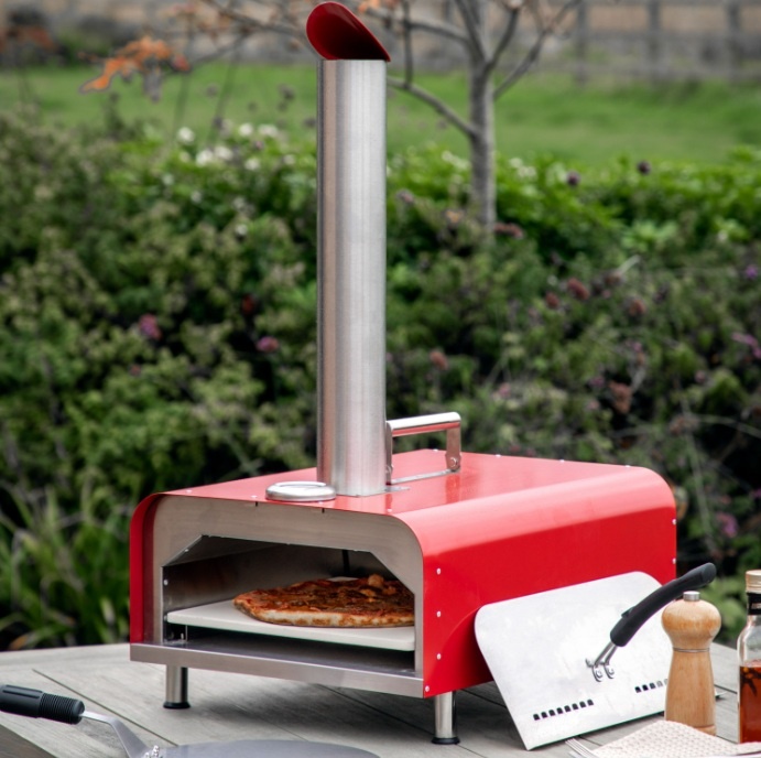 Outdoor setup featuring the Gallery Sassari Pellet Pizza Oven Red with stainless steel body and pellet-fed system