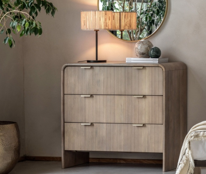 Gallery Colonna 3 Drawer Chest in natural mango wood with fluted drawers and curved top styled in a bedroom setting