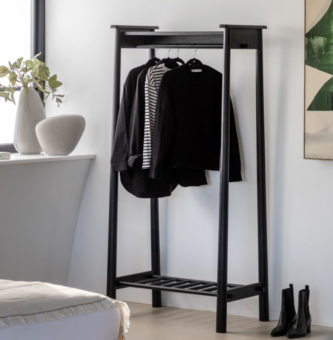 Gallery Direct Wycombe Open Wardrobe Black in a modern home with clothes hanging off the hanging rail