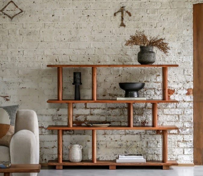 Gallery Borden Open Display crafted from solid Acacia wood with four wide asymmetrical shelves in modern industrial setting