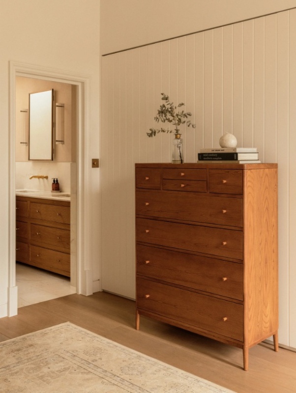 Ercol Salina 2103 8 Drawer Tall Chest | Vintage Ash in a contemporary bedroom setting against a light wall