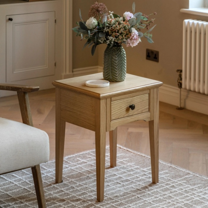 Gallery Direct Malvern 1 Drawer Side Table with vase and pink flowers on a beige rug and wood floor