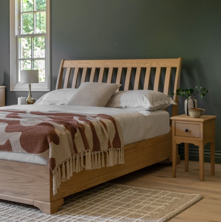 Gallery Direct Malvern Double Bed in bedroom on rug next to bedside chest with lamp with grey painted walls and white victori