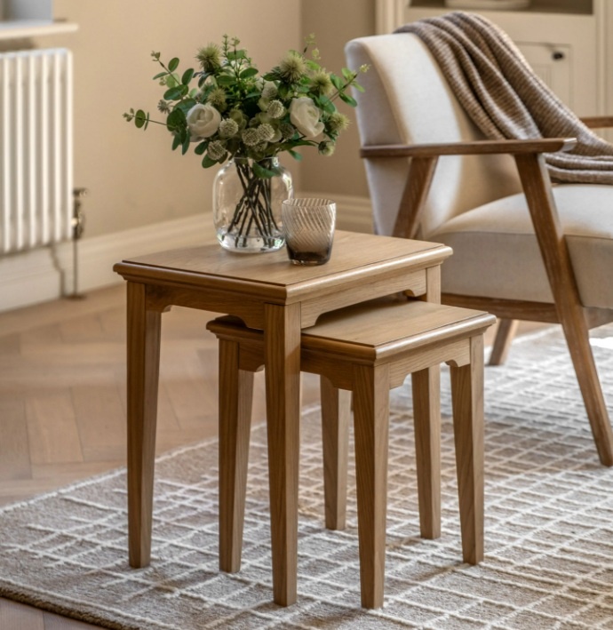 Gallery Direct Malvern Nest of 2 Tables on lush carpet with glass vase and flowers on top