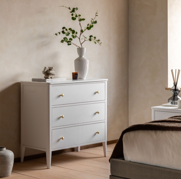 Elegant bedroom interior featuring the Gallery Direct Acton 3 Drawer Chest White with brass handles and clean painted finish