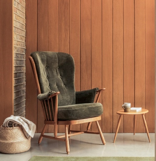 Ercol 7913 Evergreen Chair against a wood panelled wall
