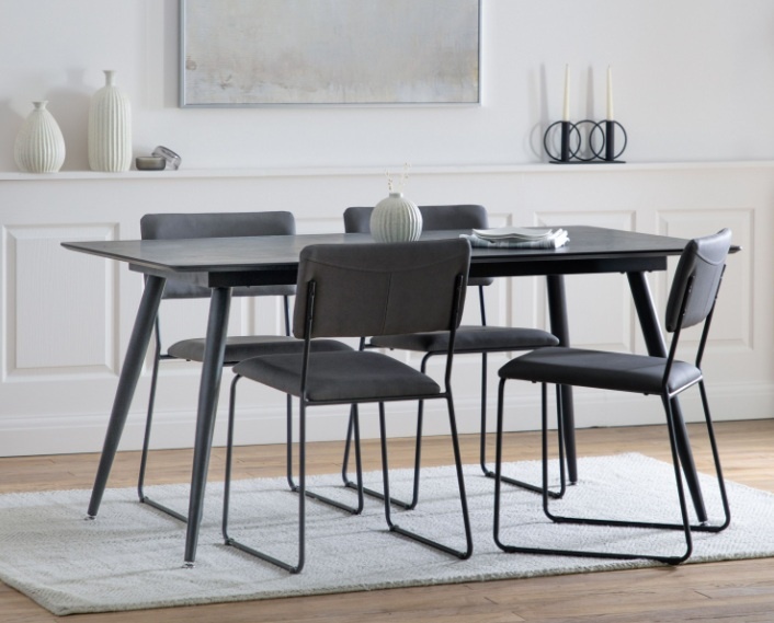 The Gallery Direct Astley Black Oak 160cm Dining Table with chairs set in a dining room