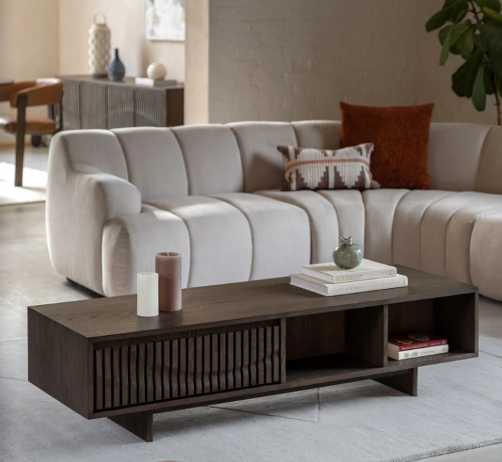 Gallery Direct Onda 1 drawer coffee table in walnut shown in a modern living room with open shelf storage