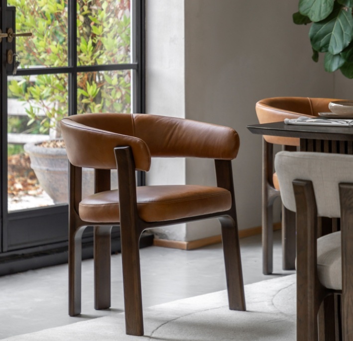 Gallery Direct Onda dining chair in brown leather styled at a modern dining table