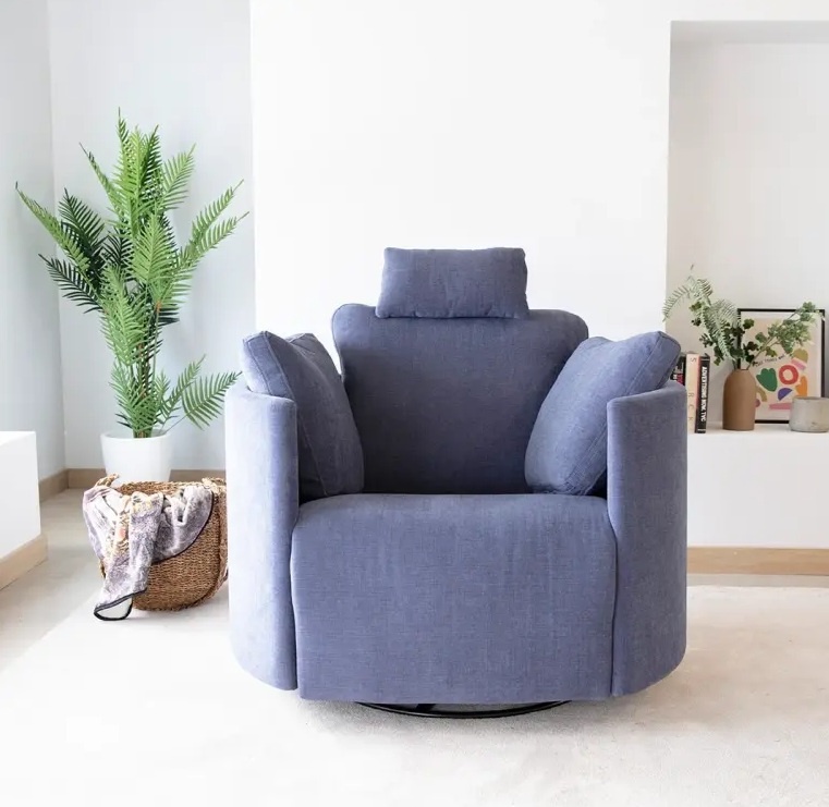 Fama Moonrise Big oversized power recliner in blue fabric in lounge next to plant - front view