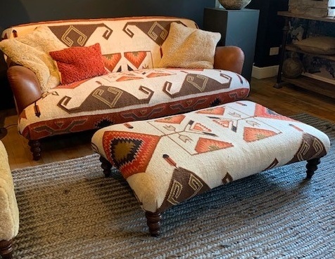 Tetrad Dakota Large Rectangular Stool in a traditional lounge setting next to Midi sofa
