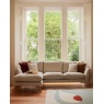 Ercol 4332 Forli Chaise LHF sofa in Oatmeal textured fabric positioned under large triple sash windows in a modern Scandi liv