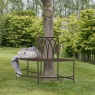Gallery Alberoni Ember metal tree surround bench in a woodland garden setting